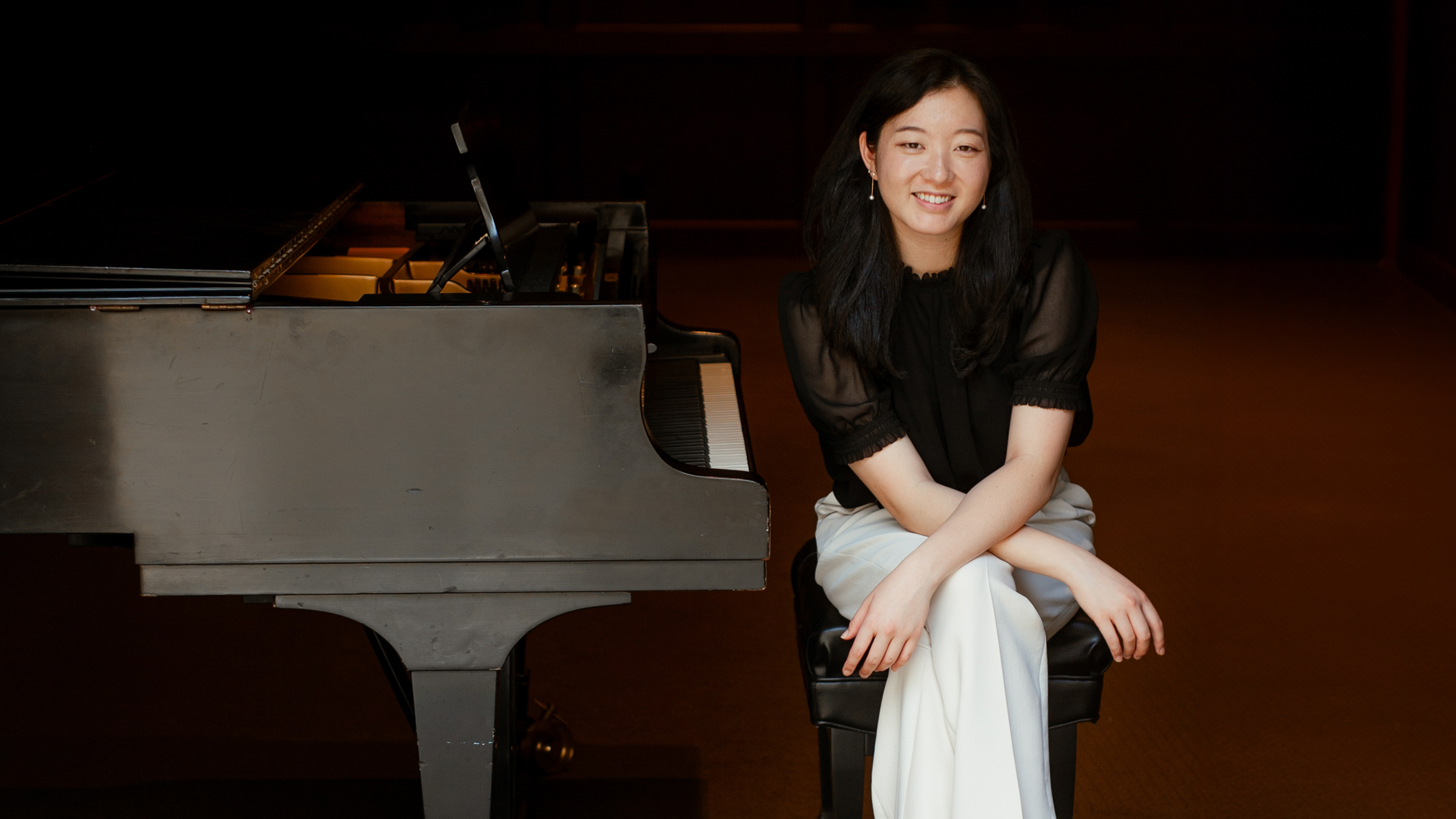 Cameron Akioka sits at the piano.